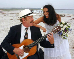 Terrence Farrell plays guitar at a beach wedding